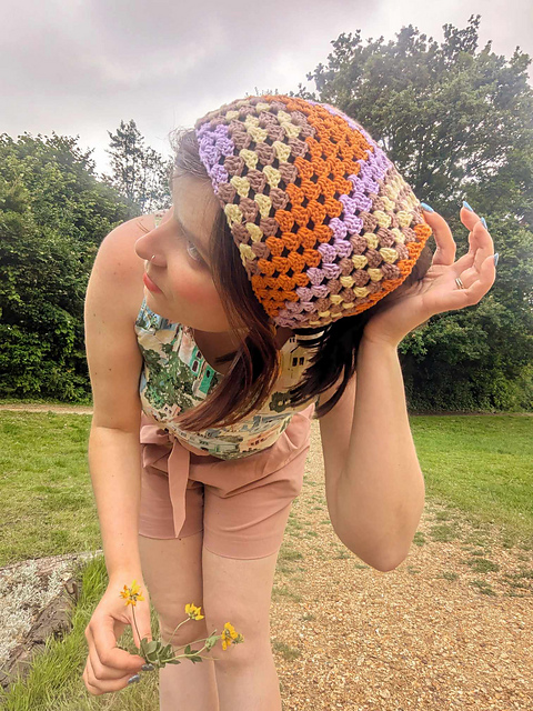 Side view of multicolor granny crochet bandana worn outdoors