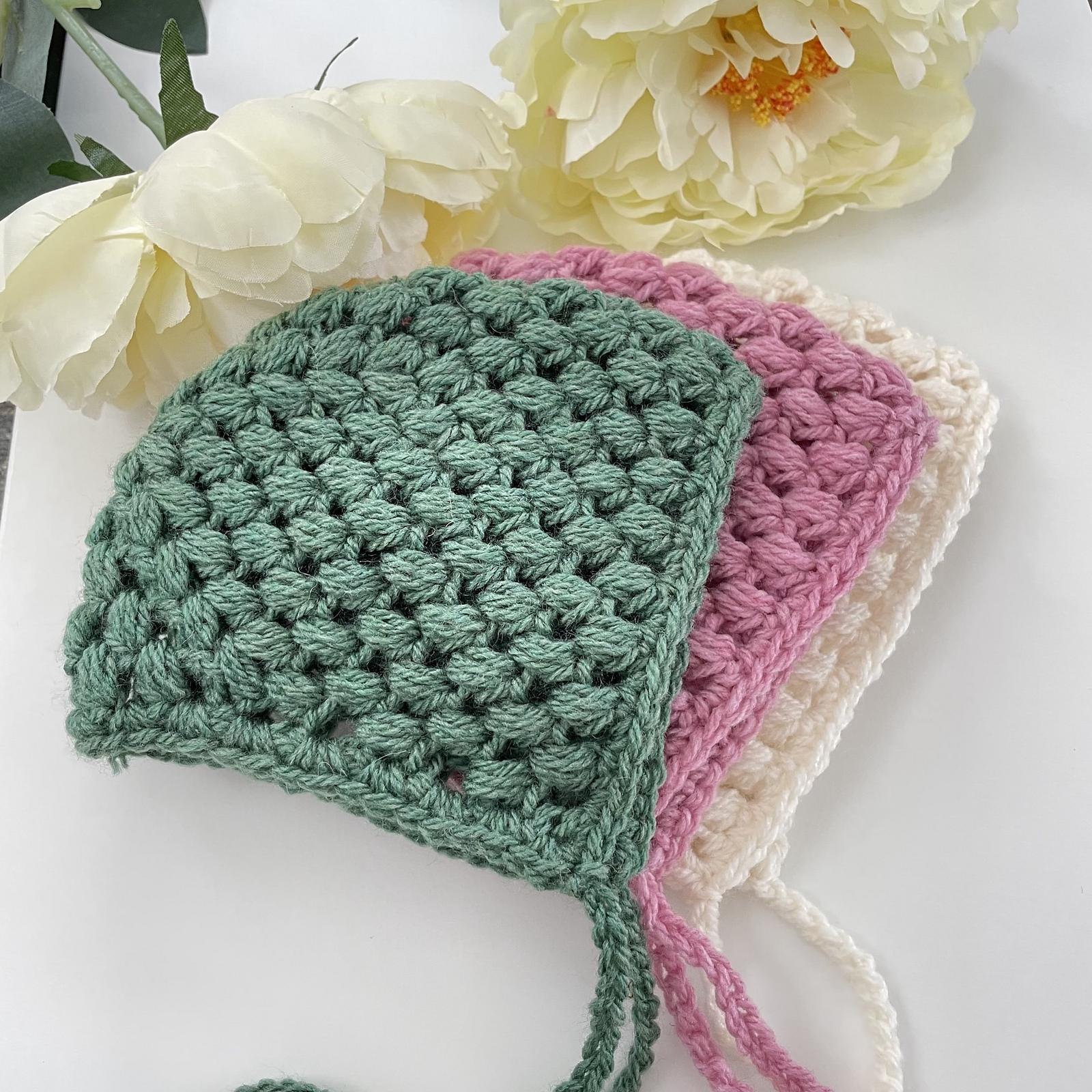 Green pink and cream puff-stitch crochet baby bonnets by Frisian Knitting