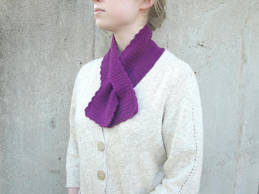 Purple scalloped crochet keyhole scarf worn neatly around the neck