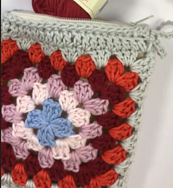 Close-up of the colorful granny square zip pouch by Bluebird and Daisy