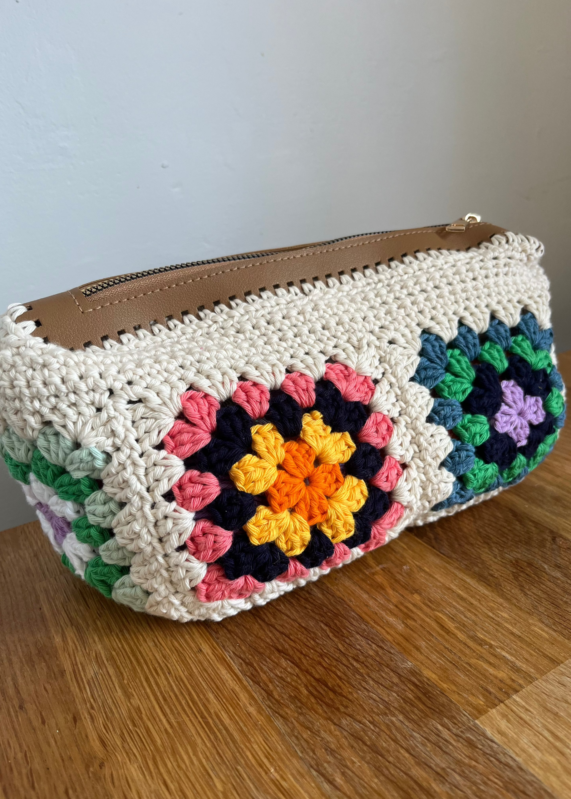 Cream granny square pouch with colorful centers and a brown zipper by Crafted by Cat