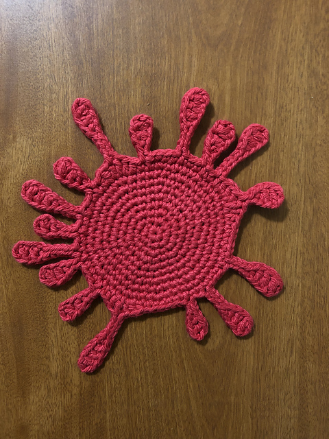 Red crochet blood splat coaster by Candy Downs