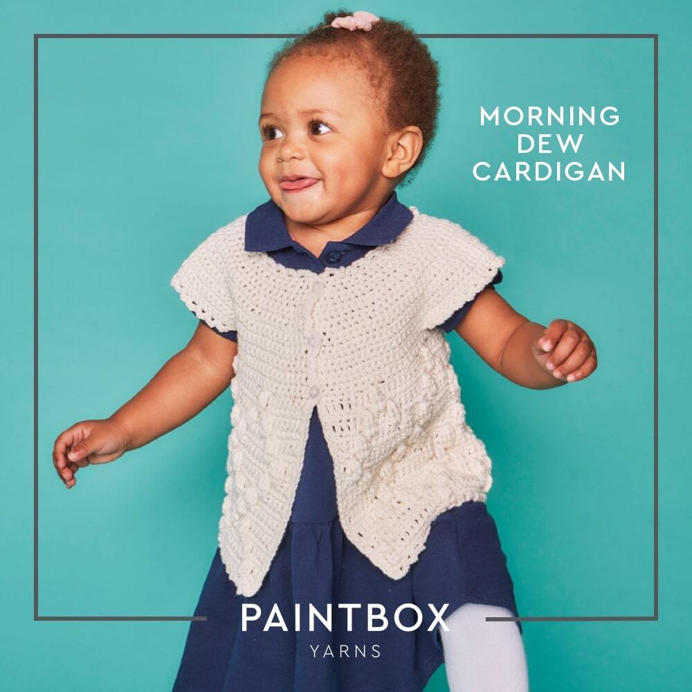 Baby wearing the pale short-sleeved Morning Dew crochet cardigan