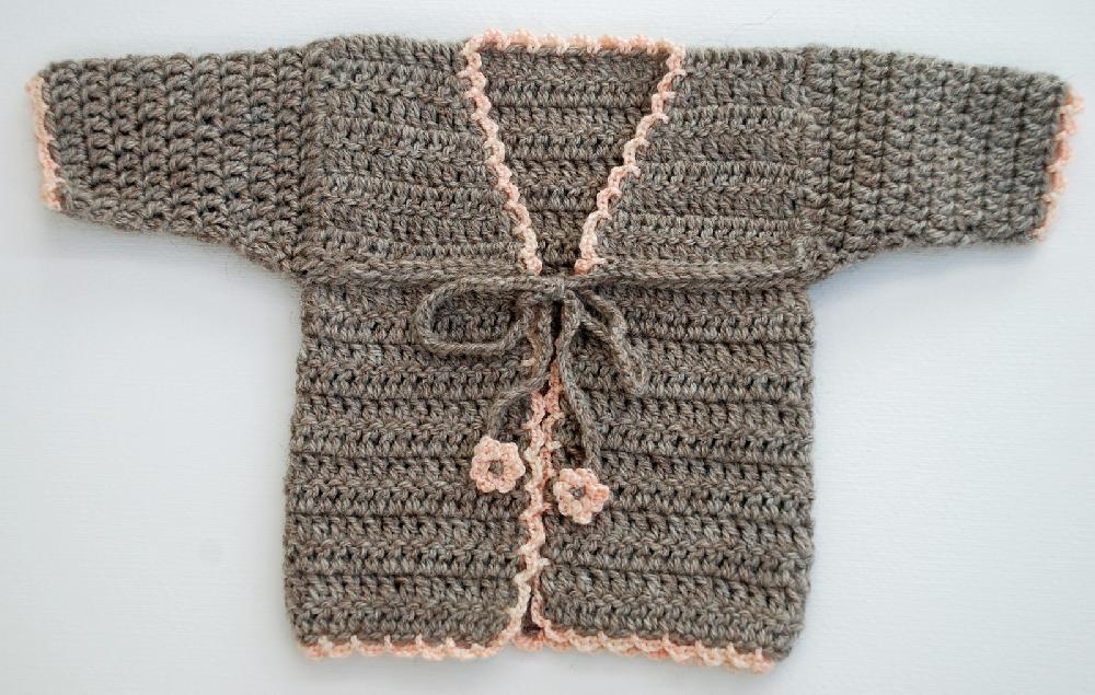Gray crochet baby cardigan with an open front and small tie details