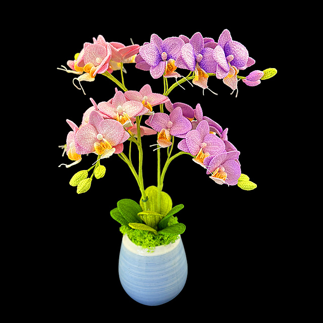 Crocheted pink and purple Phalaenopsis orchid stems arranged in a pot