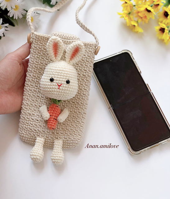 Cream crochet phone pouch decorated with a rabbit and a small orange carrot
