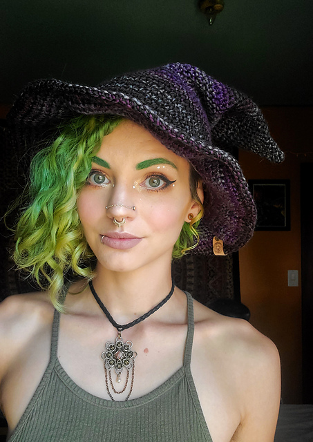 Dark crochet witch hat with a soft slouching crown and brim