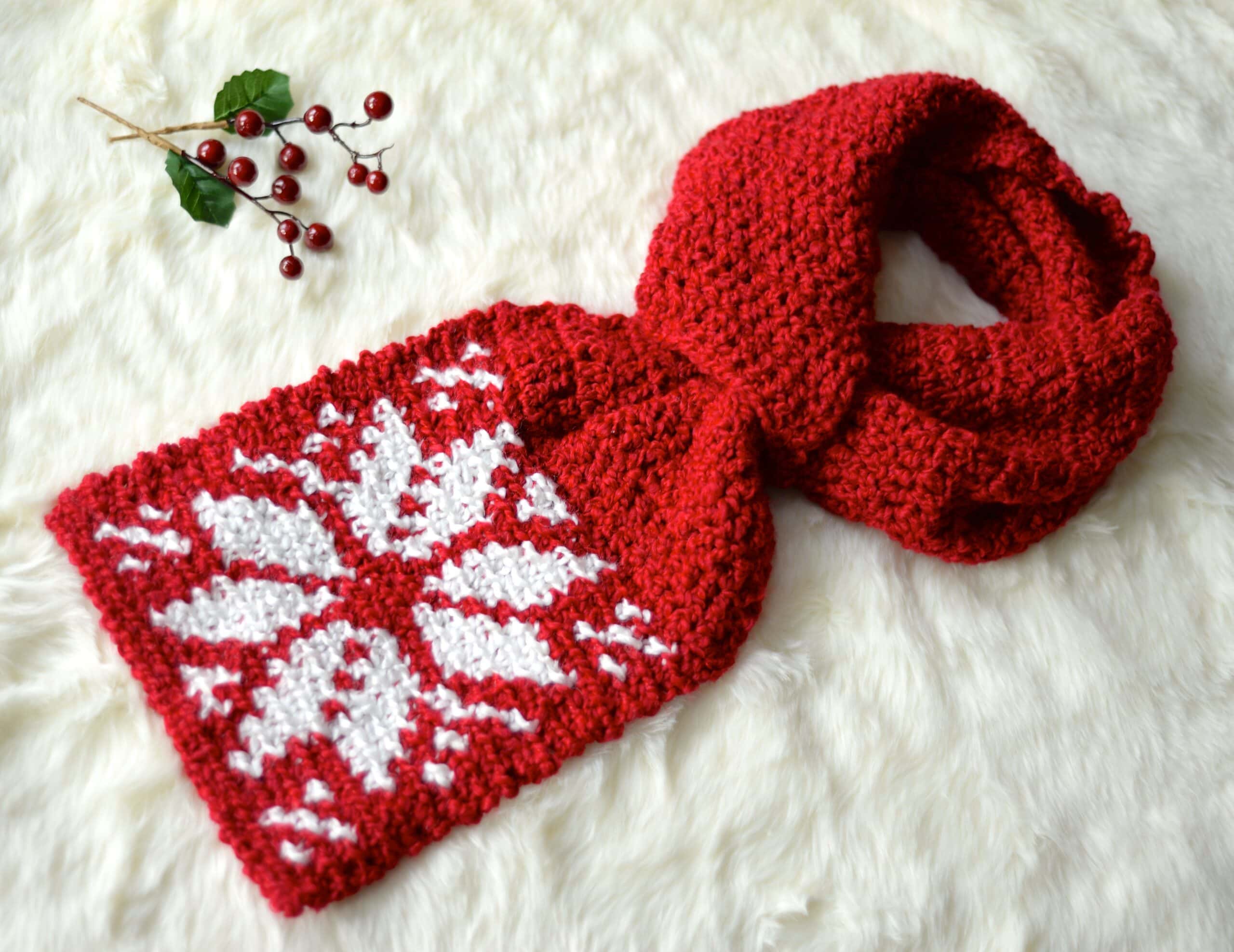 Red crochet keyhole scarf with a contrasting white snowflake motif