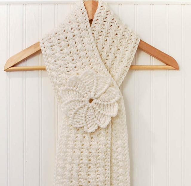 Cream textured crochet keyhole scarf with a large spiral flower