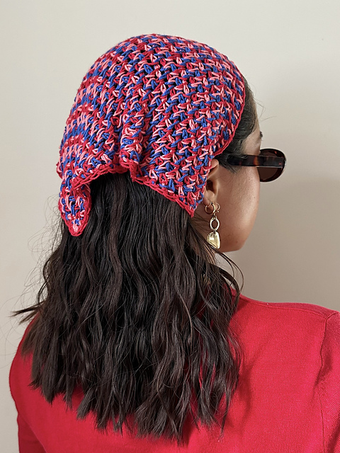 Three-color Tunisian crochet bandana in red and blue tones worn over dark hair