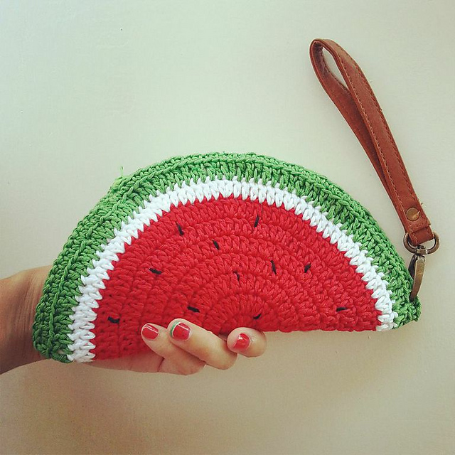 Crocheted watermelon slice pouch with a green rind and red center