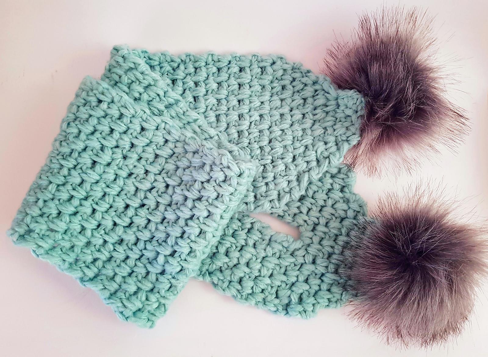 Pale blue crochet keyhole scarflet with textured fabric and dark pom-poms
