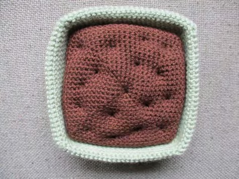 Crochet and shape the dark-brown soil