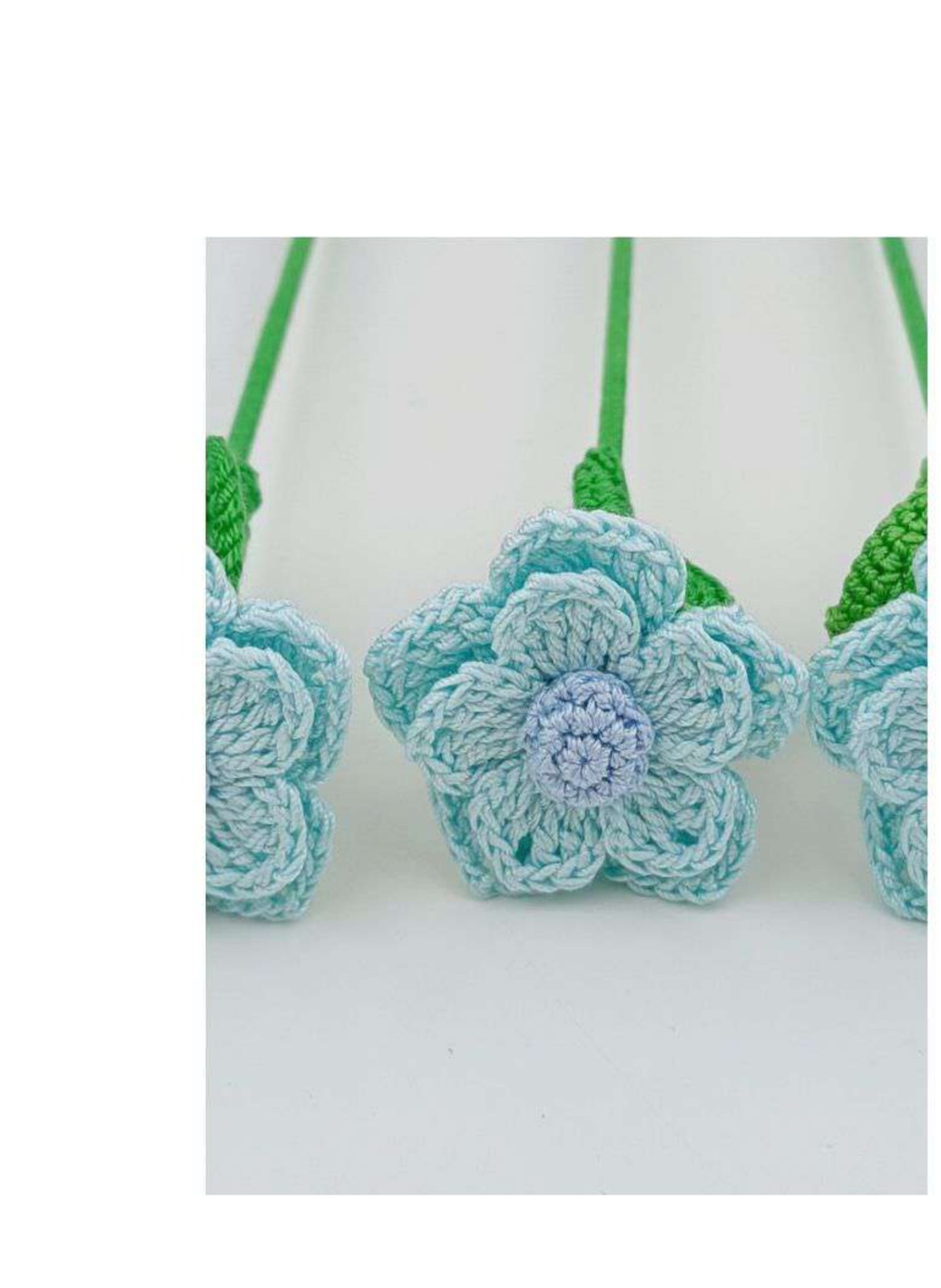 Blue crochet flower with five inner petals and five larger outer petals