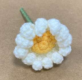 White crocheted daisy with yellow center