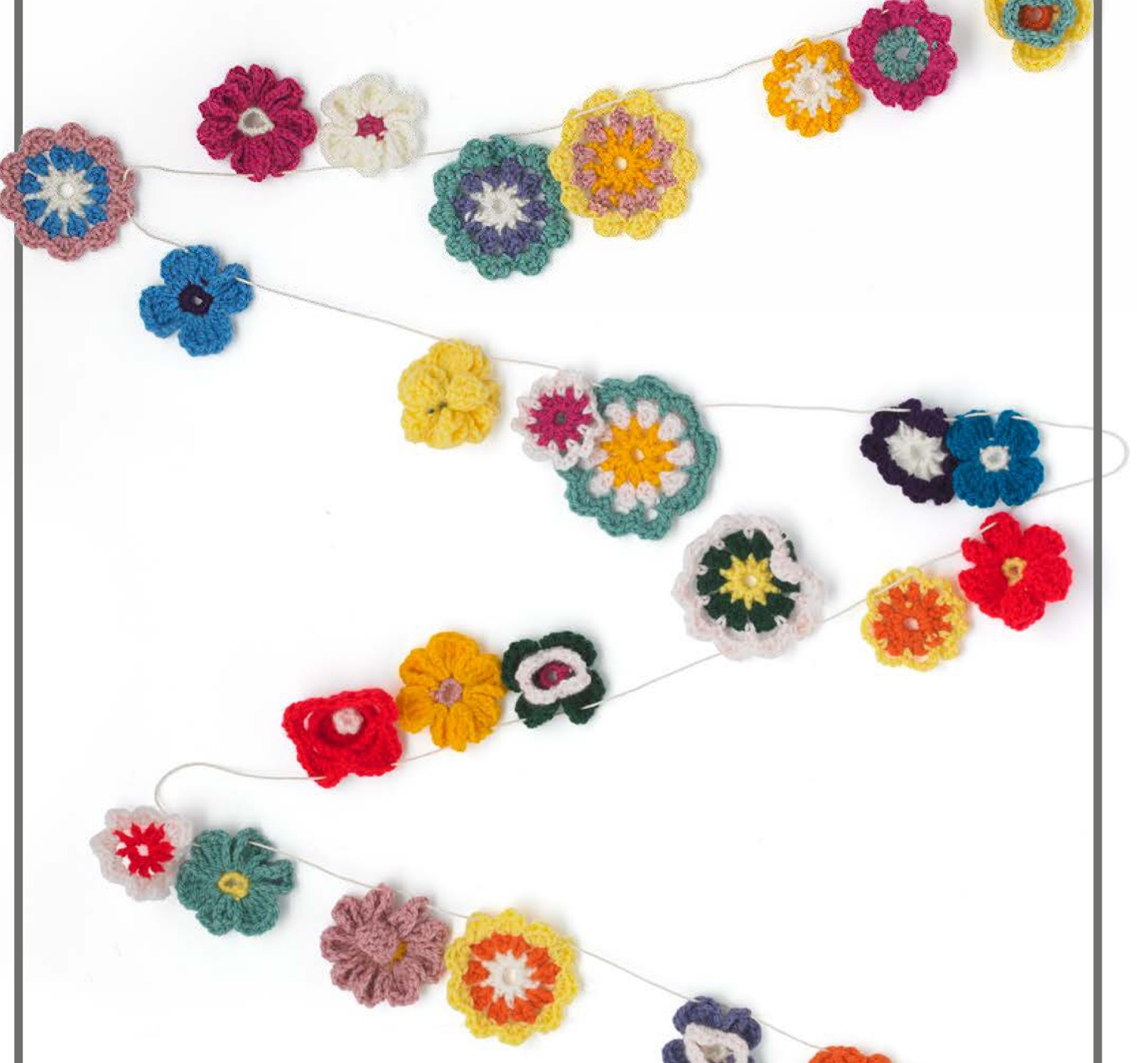Colorful crochet garden garland with mixed flower motifs on a cord