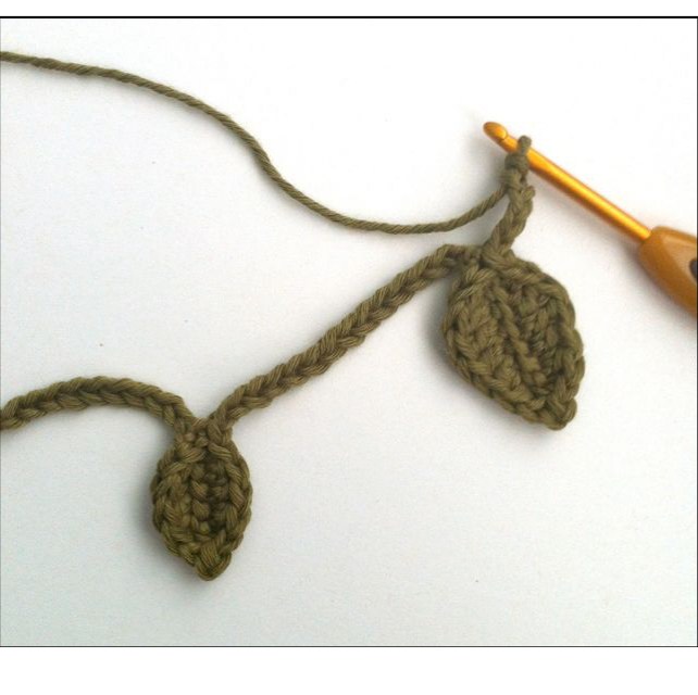 Small crochet leaf being worked along the foundation chain