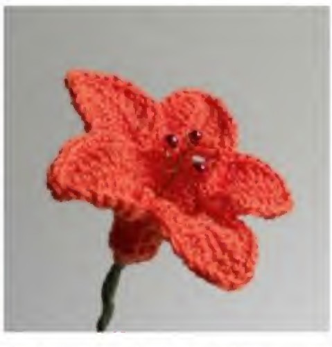 Orange crochet bellflower with five pointed petals and red bead stamens