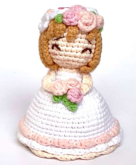 Crochet bride amigurumi with a flower crown and white skirt