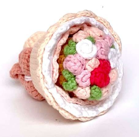 Crochet reversible bouquet with pastel flowers inside a cream wrapper