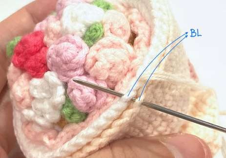Joining the back loops of the two crochet shells around the bouquet rim