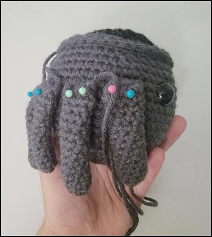 Crochet spider pot with paired leg groups around its sides