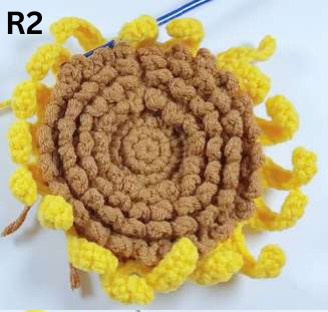 First layer of yellow crochet sunflower petals under construction