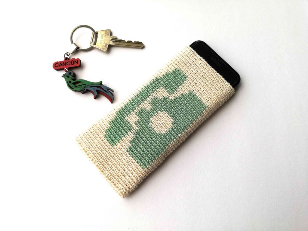 Cream tapestry crochet phone sleeve with a green vintage telephone motif by Nordic Hook