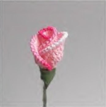Pink crochet rosebud with overlapping rounded petals