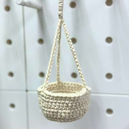 Small crochet pot suspended from three cords