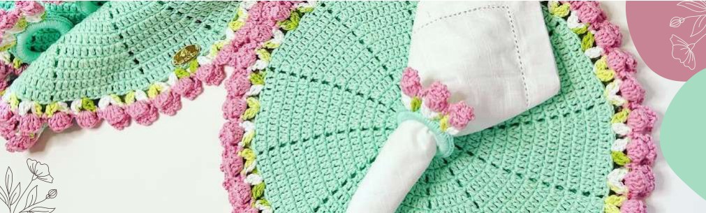 Round crochet placemat with green leaf edging and raised pink tulips