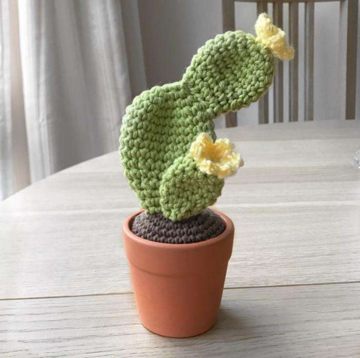 Crochet prickly pear cactus with joined green pads and yellow flowers