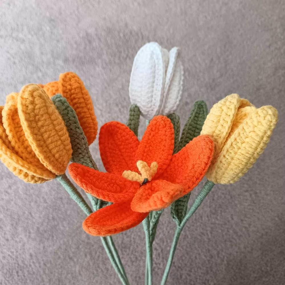 Yellow and white tulips with an open orange flower
