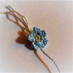 Small blue crochet forget-me-not with five cluster petals